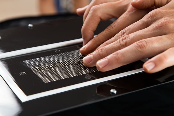 Fingers touching base unit's pins